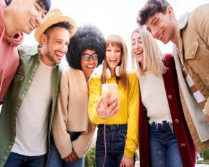 multicultural-group-of-friends-using-cell-phones-social-media