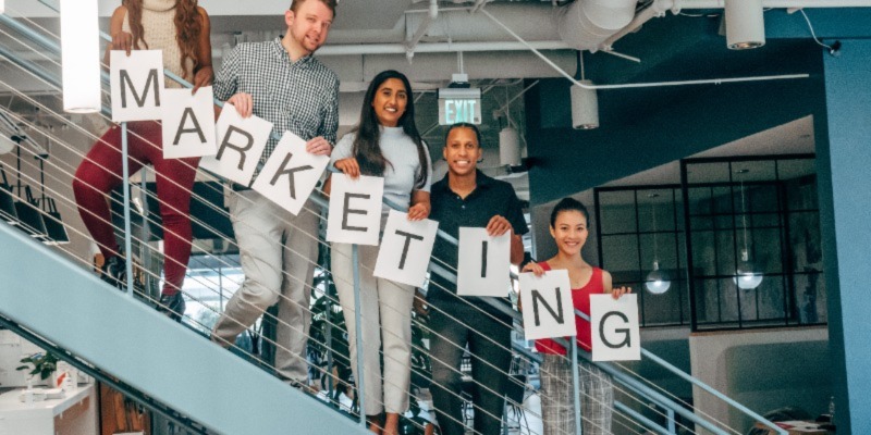 People holding a marketing banner