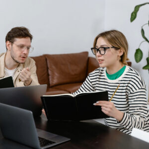 man and woman discussing in workplace