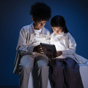 Two kids holding a tablet